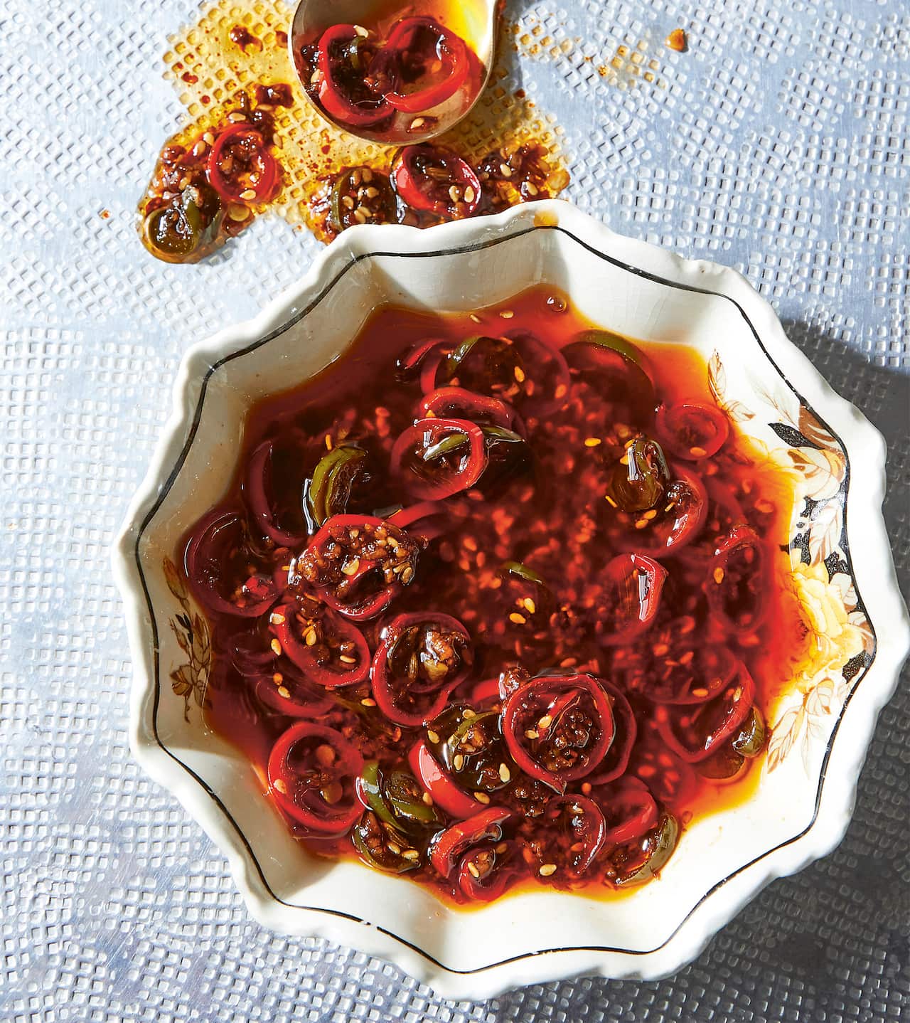 Vibrant ultimate dumpling sauce with sliced red and green chillies. 