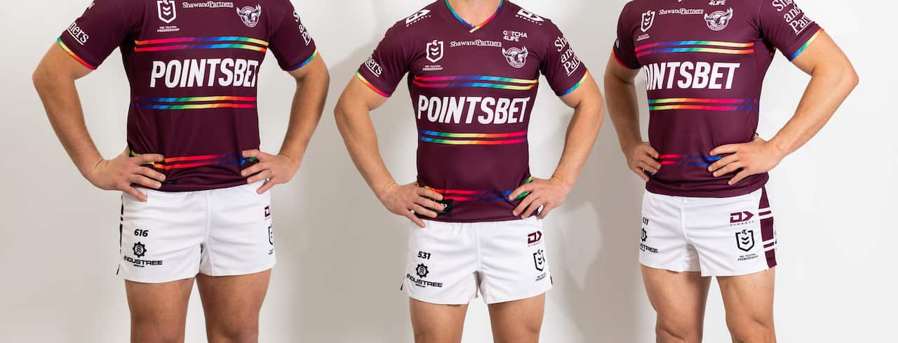 Three mean wearing a jersey.