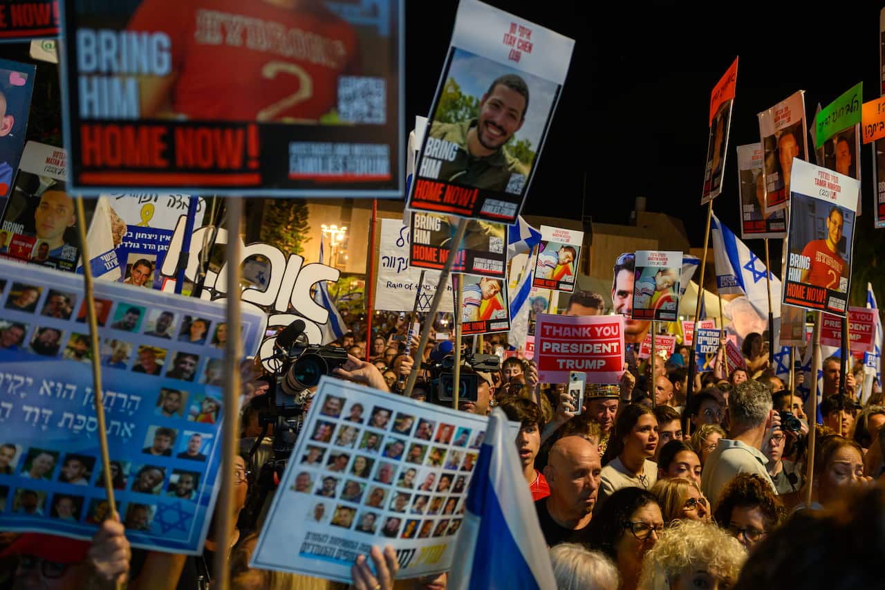 A crowd holding signs, including some that say "Thank you, President Trump".