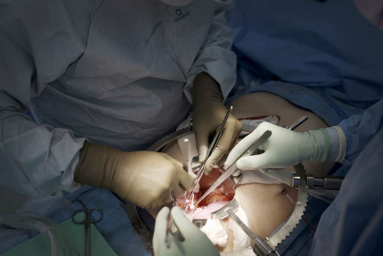 Surgeons operating on a human