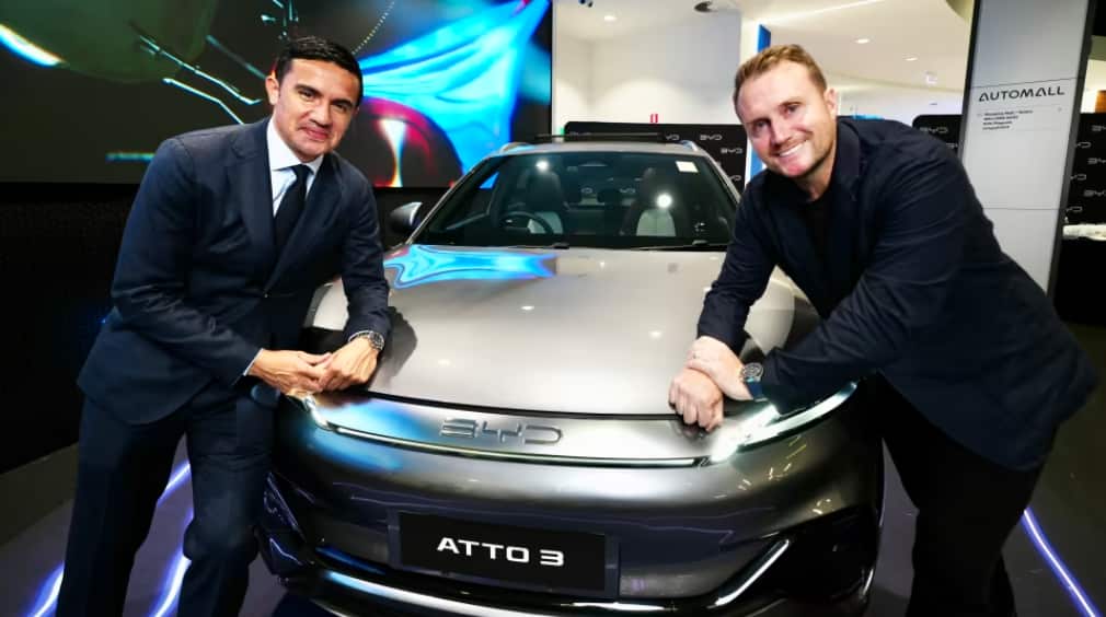 BYD brand ambassador and former Socceroos player, Tim Cahill (left) with EVDirect's Luke Todd (right).