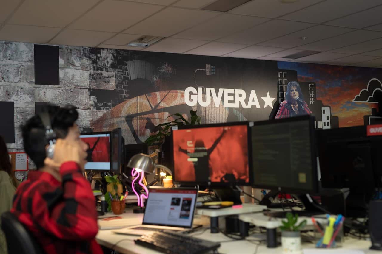 A still image from a recreation scene that depicts Guvera's office in 'Red Flag: Music's Failed Revolution'