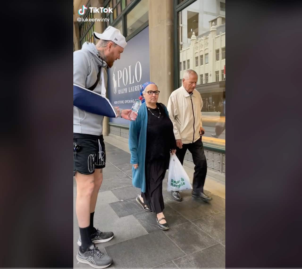 A man handing a couple a bottle 