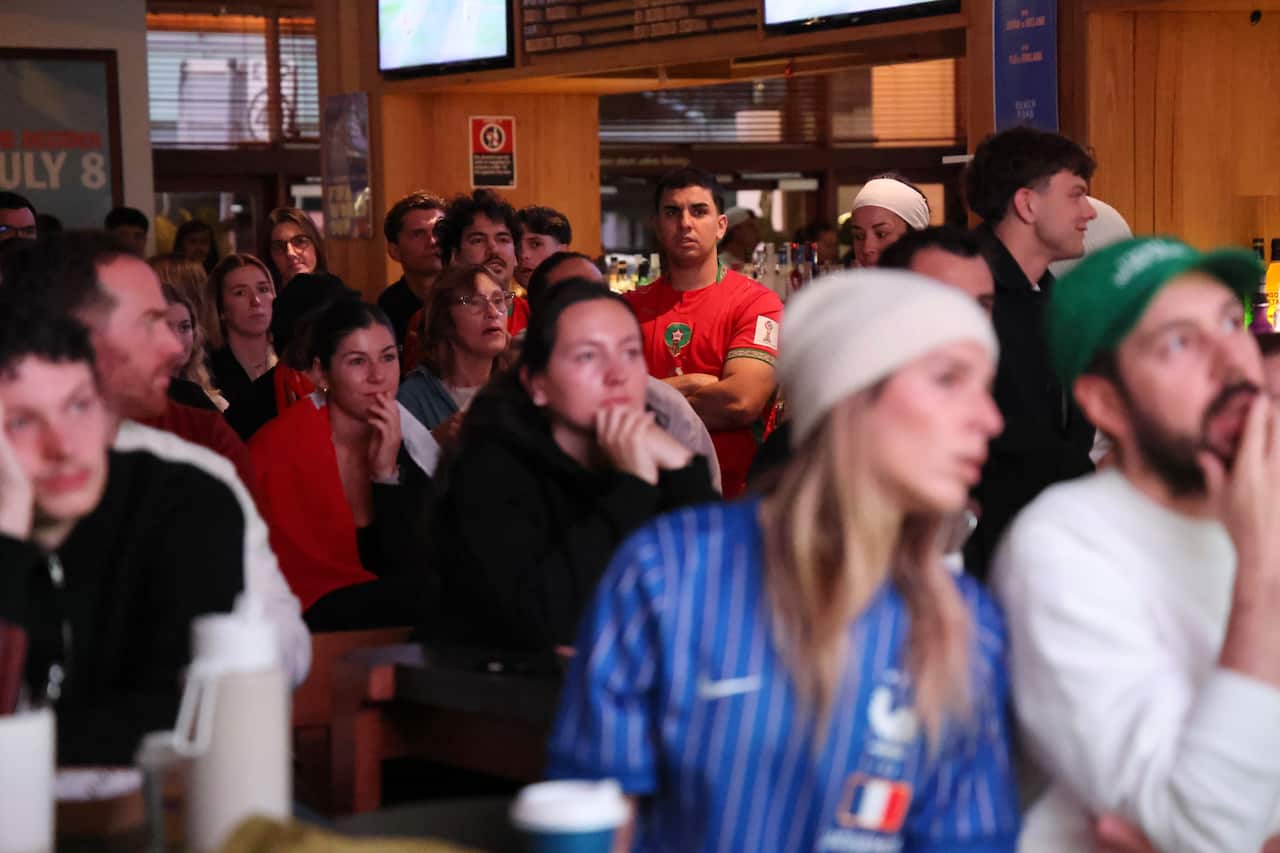 Football fans look stressed in Moroccan and French colours.