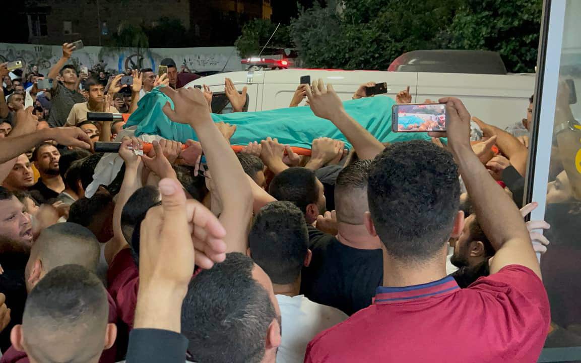 Palestinians carry the body of 15 year old Palestinian kid Zaid Muhammad Said Ganim who shot dead by Israeli forces on May 27, 2022 in Bethlehem, West Bank. 