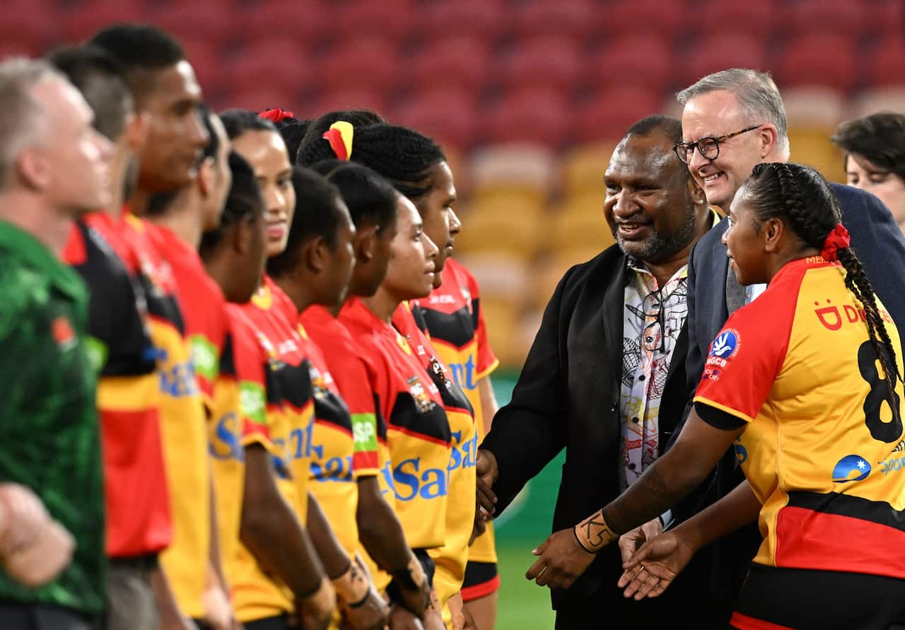PNG PM James Marape and Australian PM Anthony Albanese meet players before the Rugby League match between the Australian Prime Minister's XIII and the Papua New Guinea Orchids at Suncorp Stadium in Brisbane in September 2022.