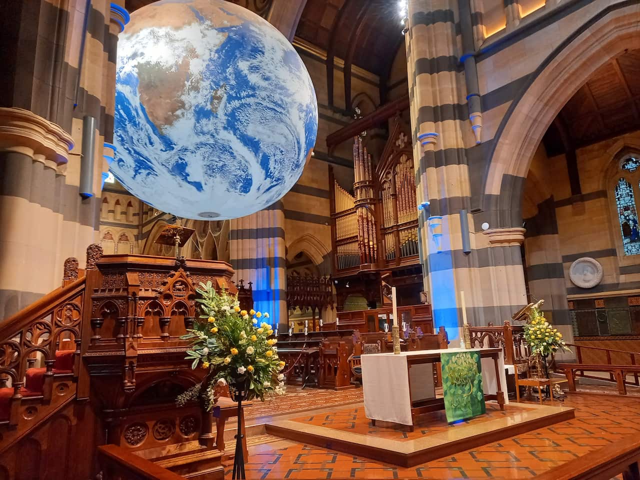 Globe art installation inside a cathedral.