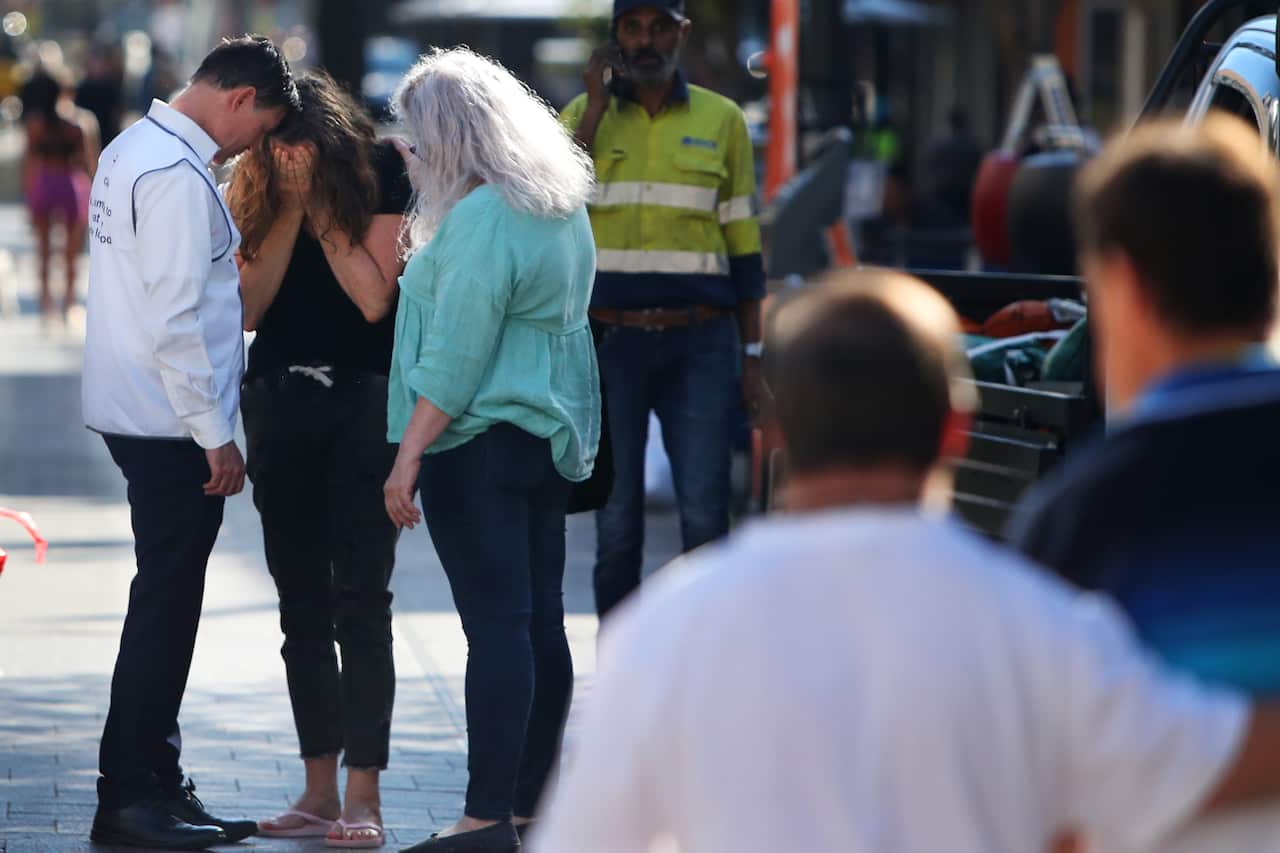 A crying woman being comforted