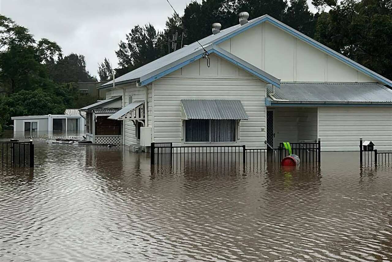 A white house inundated by floodwaters.