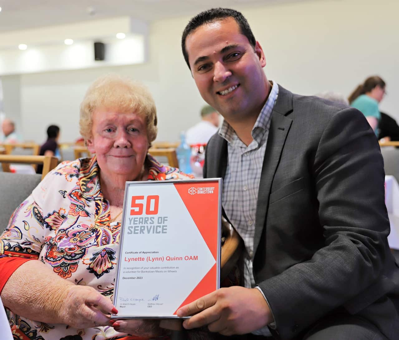 Lynn Quinn, 81, receives a 50 year service award from Canterbury Bankstown Mayor Cr Bilal El-Hayek.
