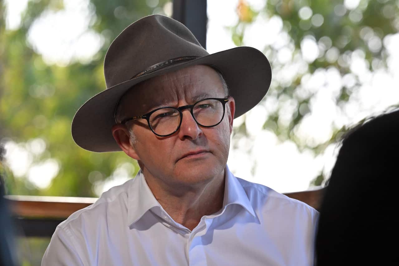 A man wearing a hat who is seated.