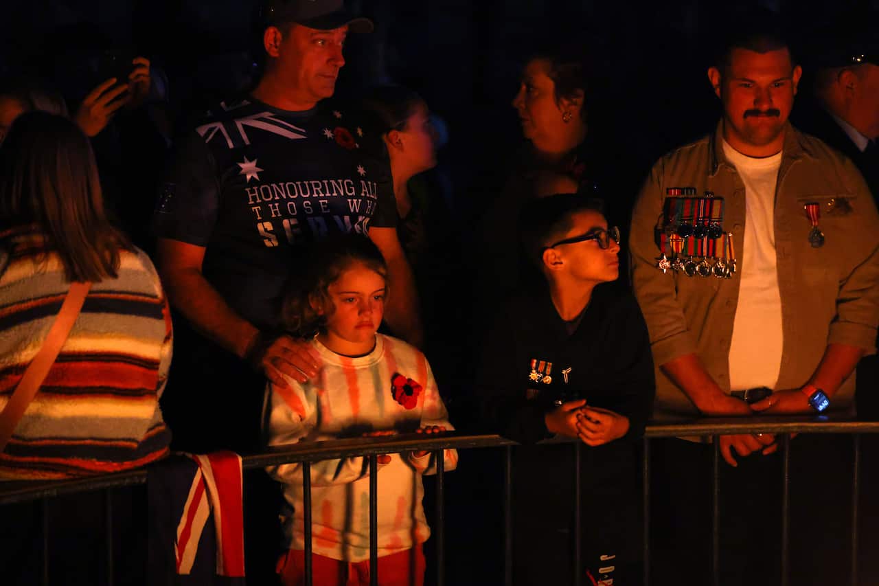 A group of people standing together  with candles.