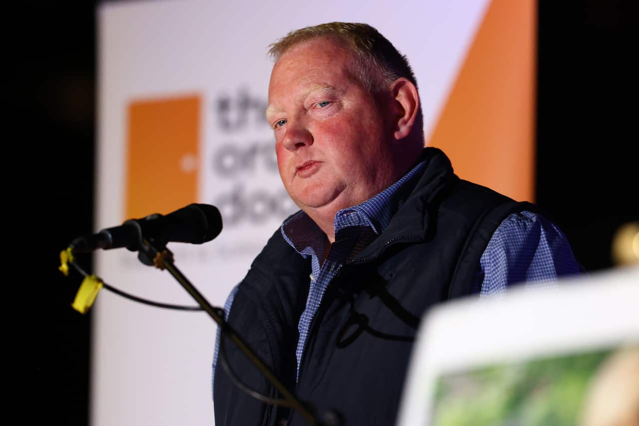 A man speaking into a microphone.