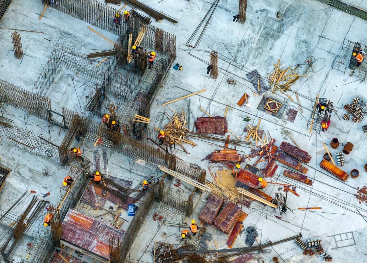 An aerial view of construction workers working on a residential project.