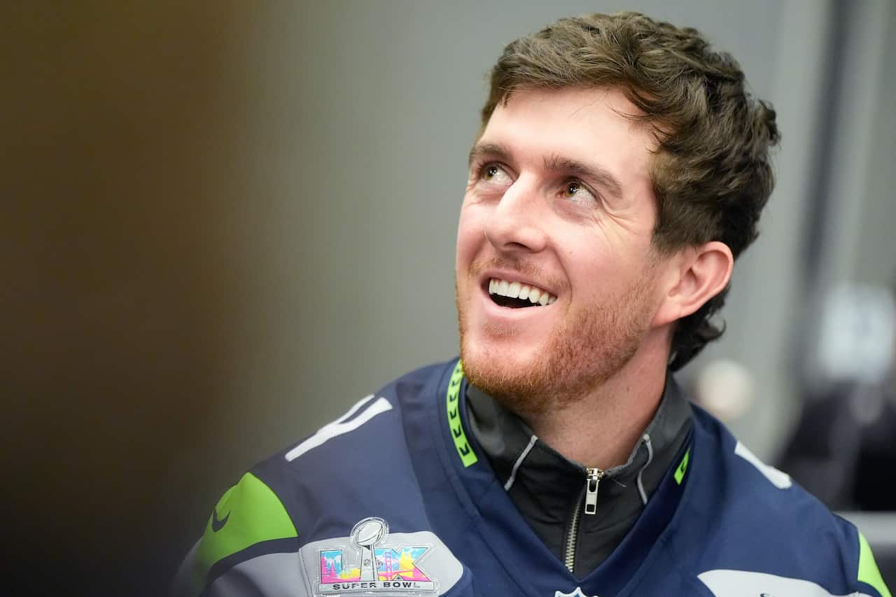 Man with short hair and beard smiles