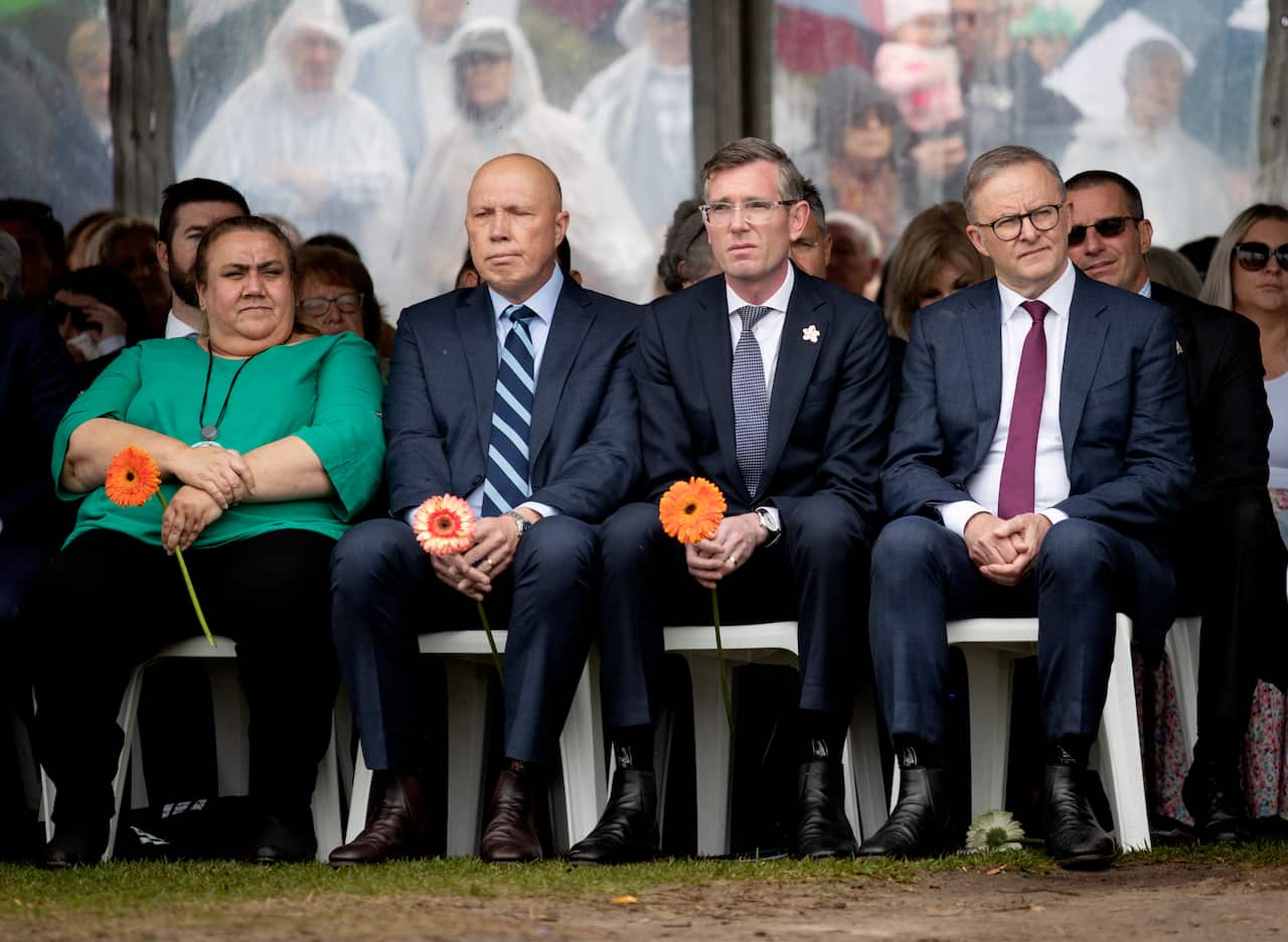 (left to right) Peter Dutton, Dominic Perrottet and Anthony Albanese wearing suits and sitting on plastic chairs outside 