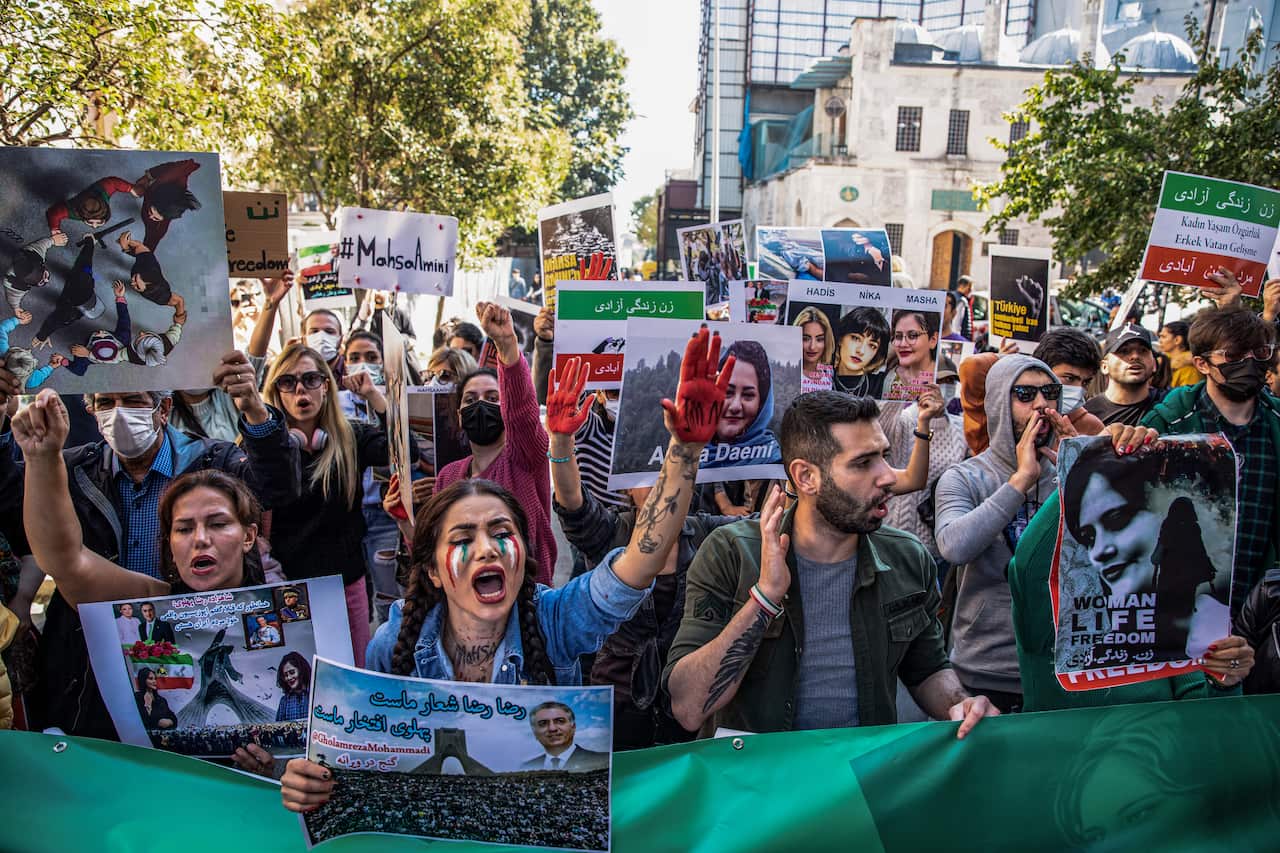 Protesters hold placards and chant slogans outside the Iranian Consulate in Istanbul, Turkey during a demonstration.