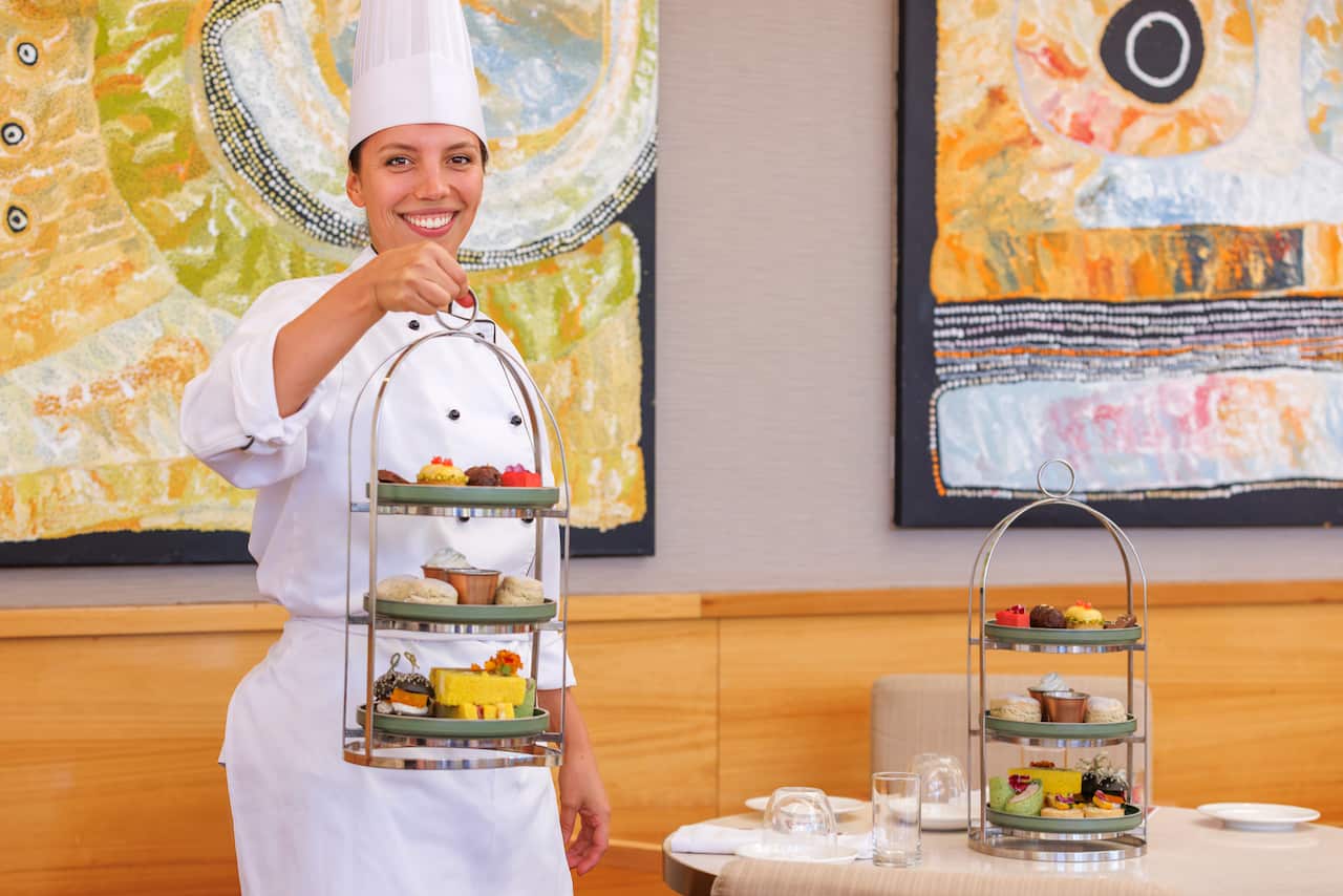 Graciela Jonen, pastry chef, standing with the native high tea at Ayers Rock Resorts