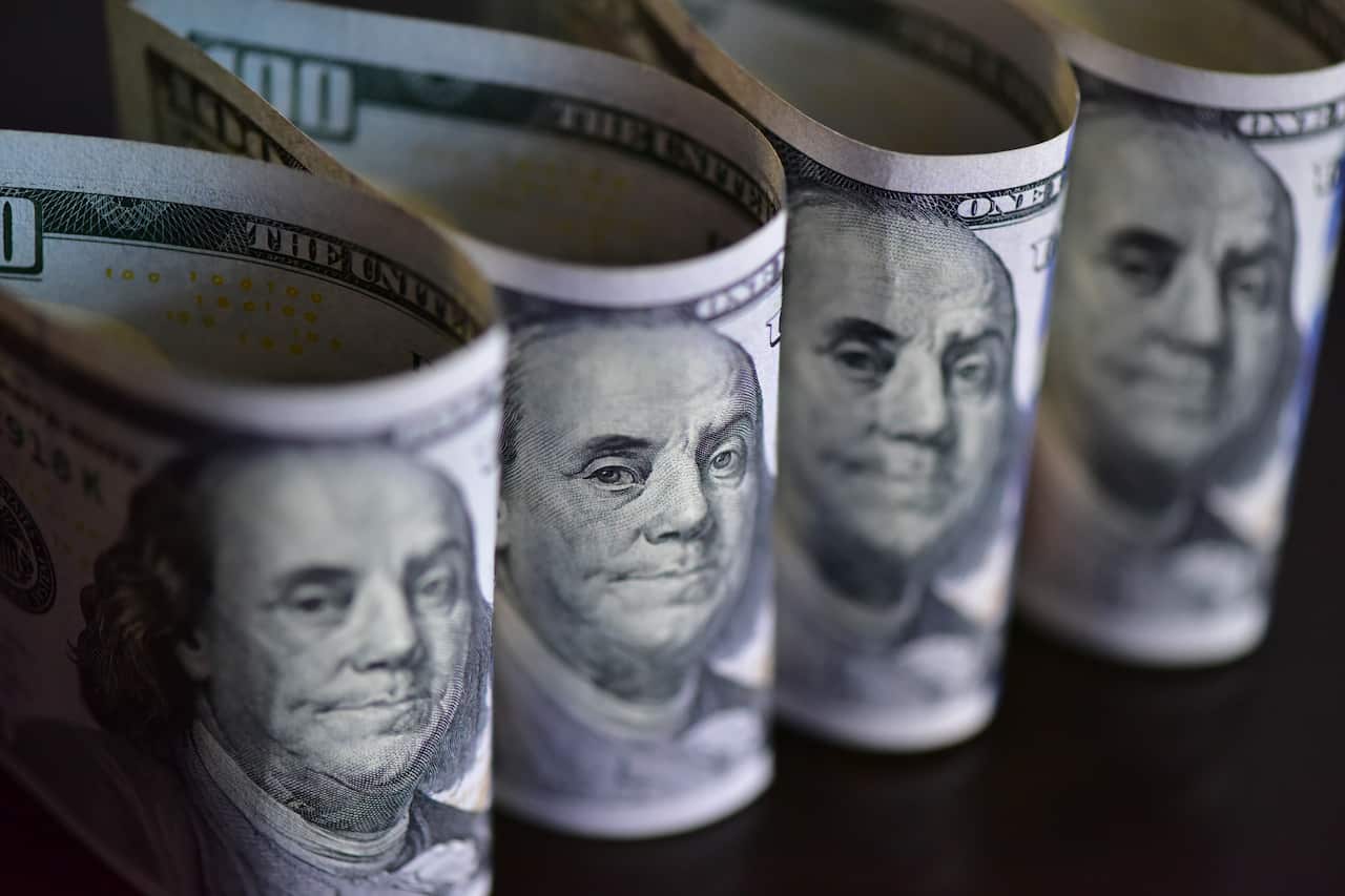Four US dollar notes stand up in a loop