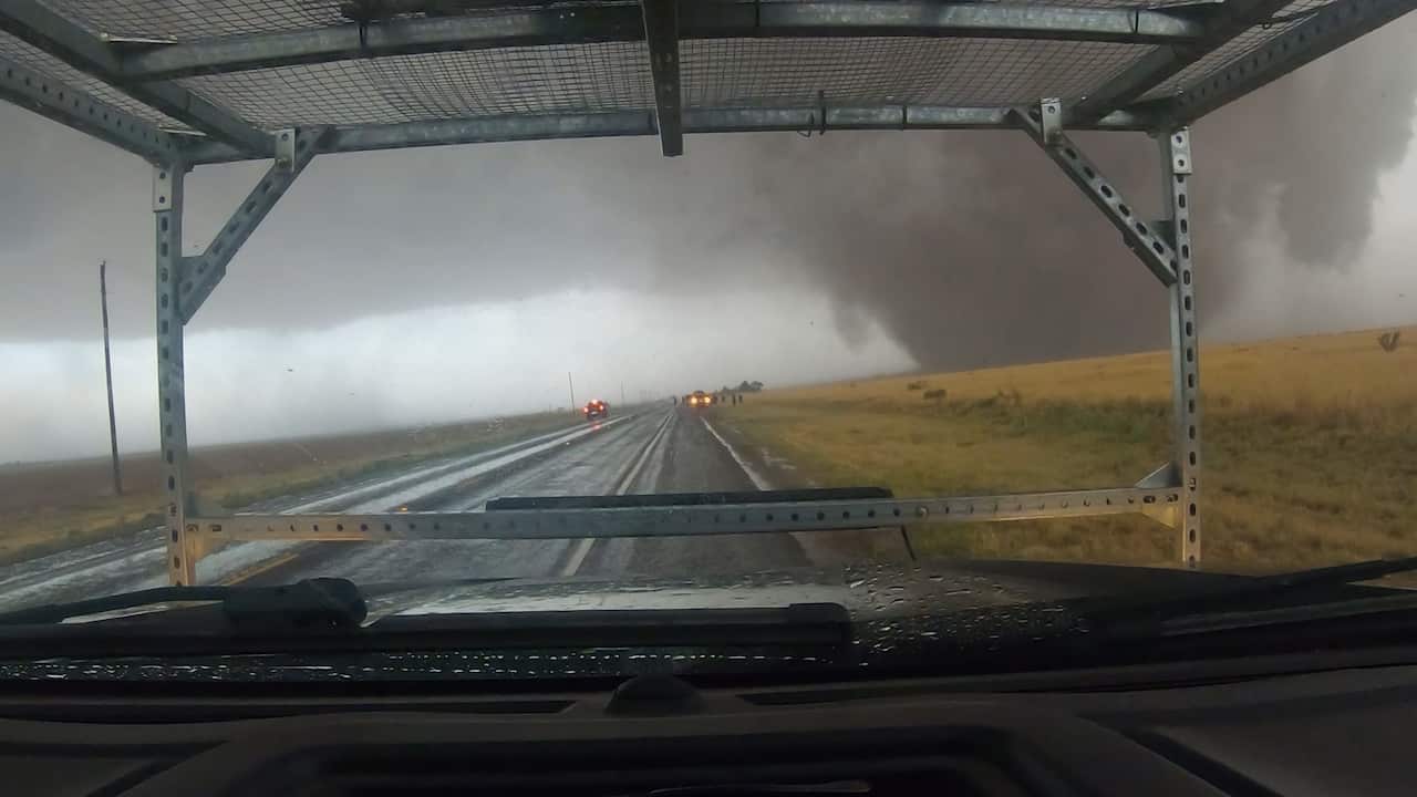 A tornado seen from inside of a car.