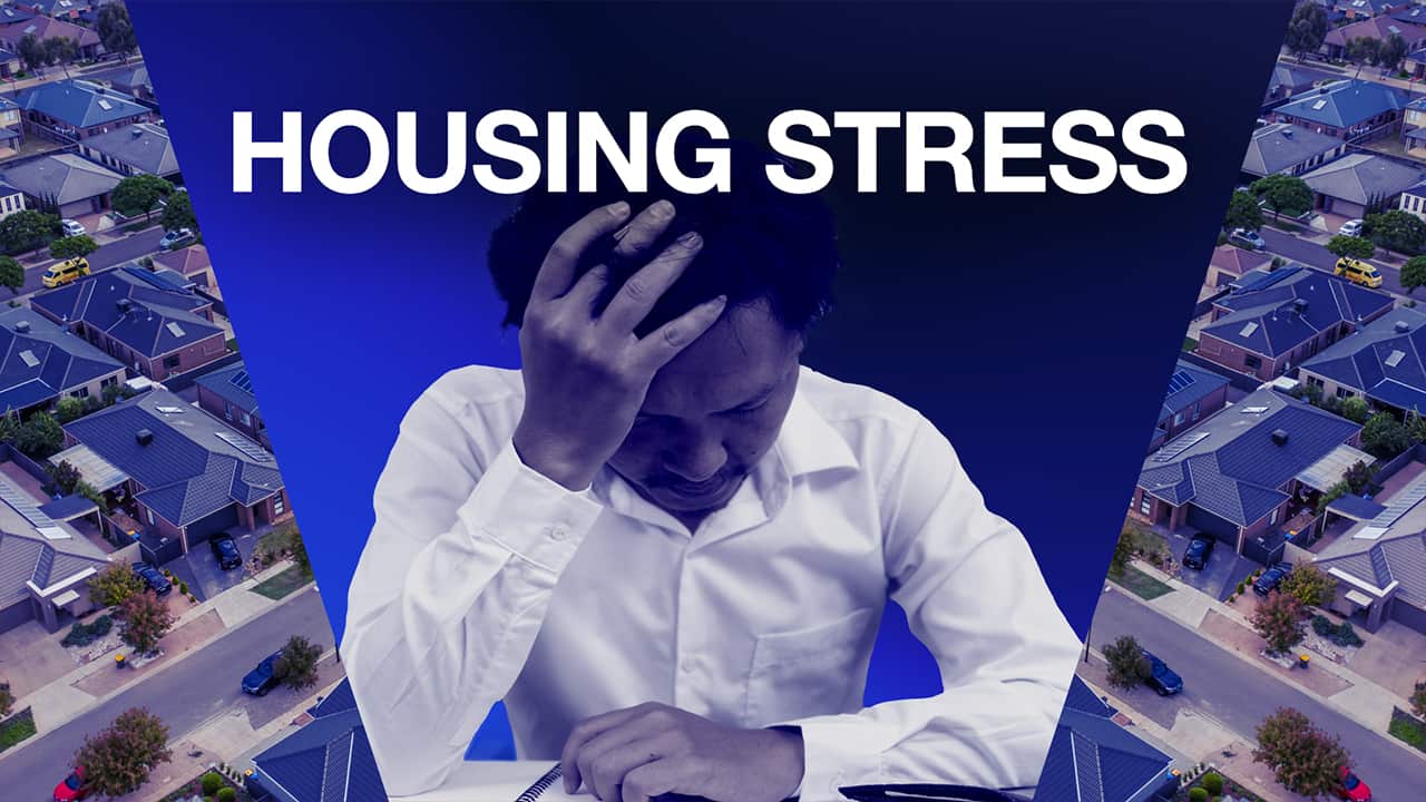 An image of a man leaning on a desk with text reading housing stress. 
