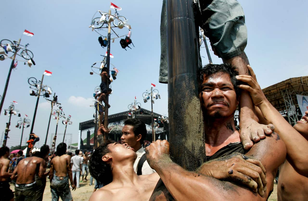 Greased pole climbing for Indonesia Independence Day