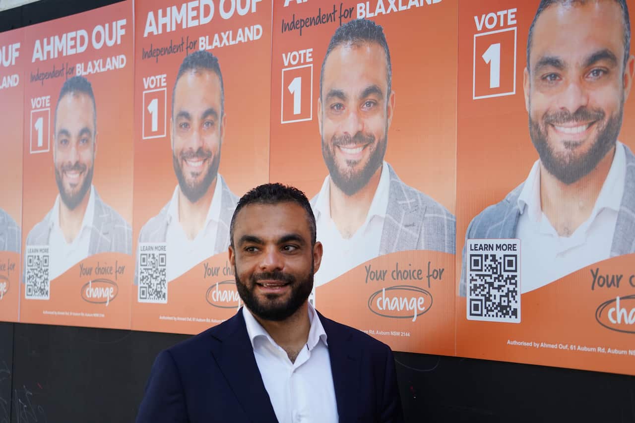 A man in a dark suit and white shirt 