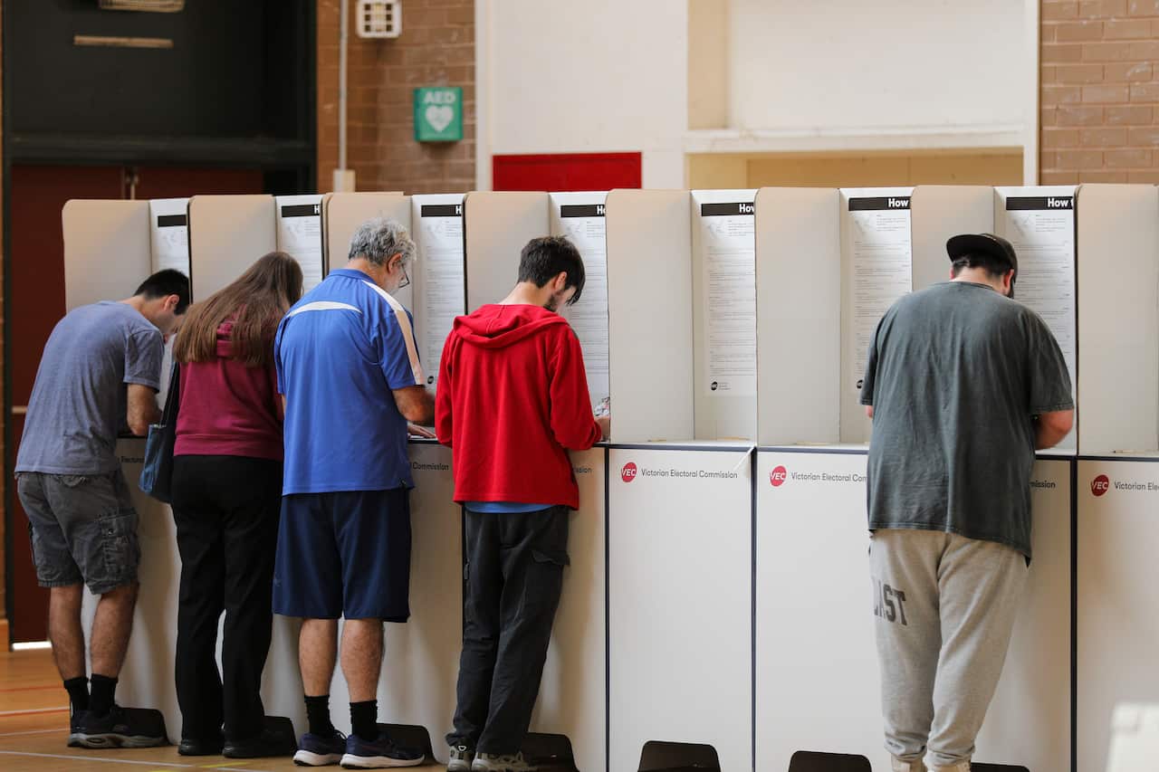 Voters cast their vote at a polling centre