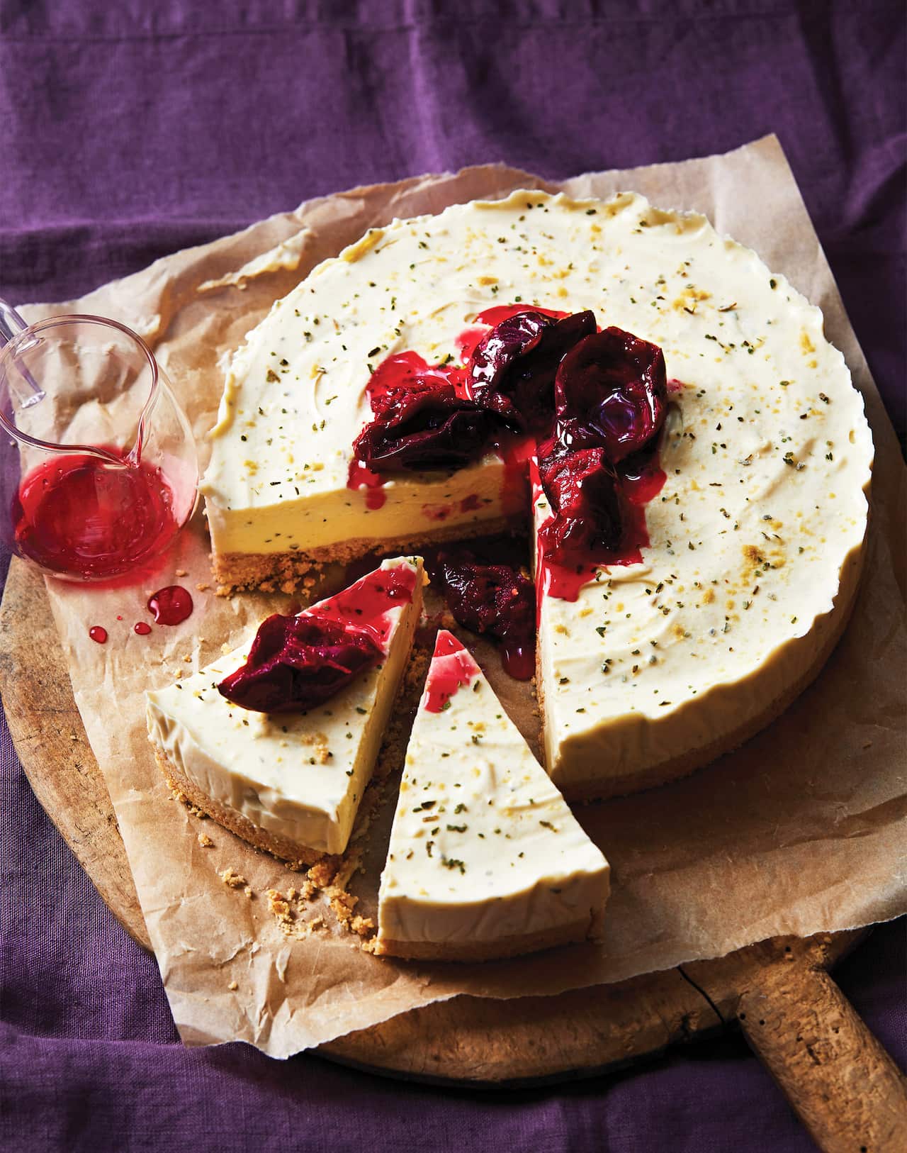 Davidson plum cheesecake, topped with plums in a vibrant syrup.