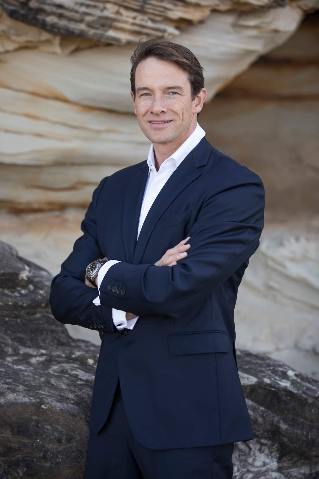 A man in a navy blue suit.