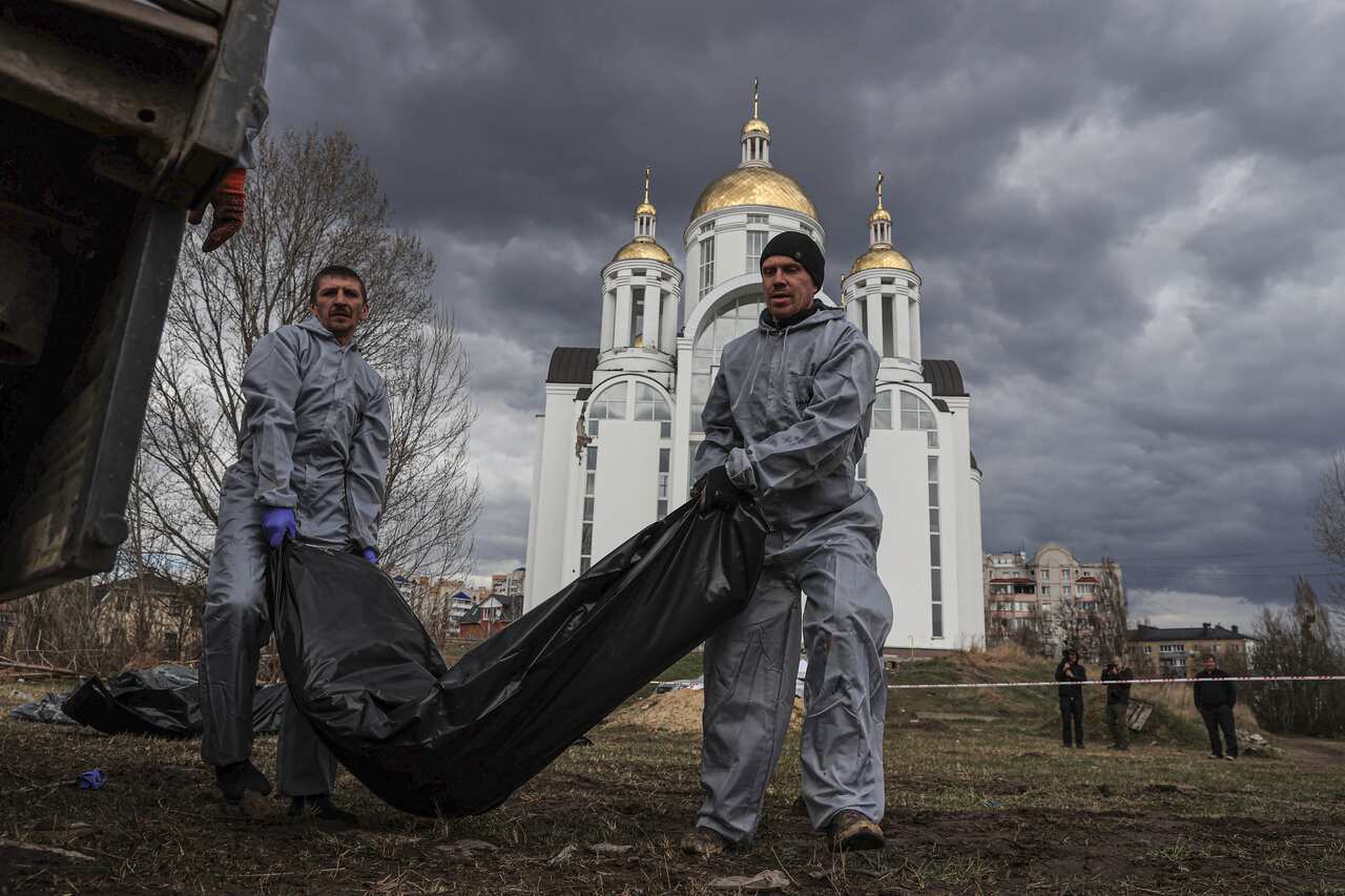 Officials are seen carrying a body.