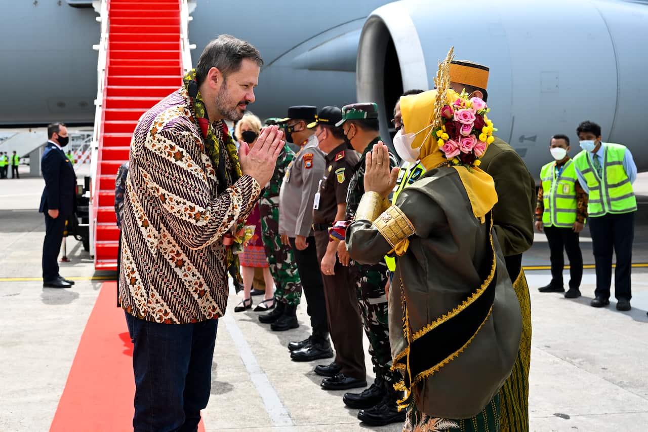 Industry Minister Ed Husic receives a traditional welcome on arrival in Makassar, Indonesia