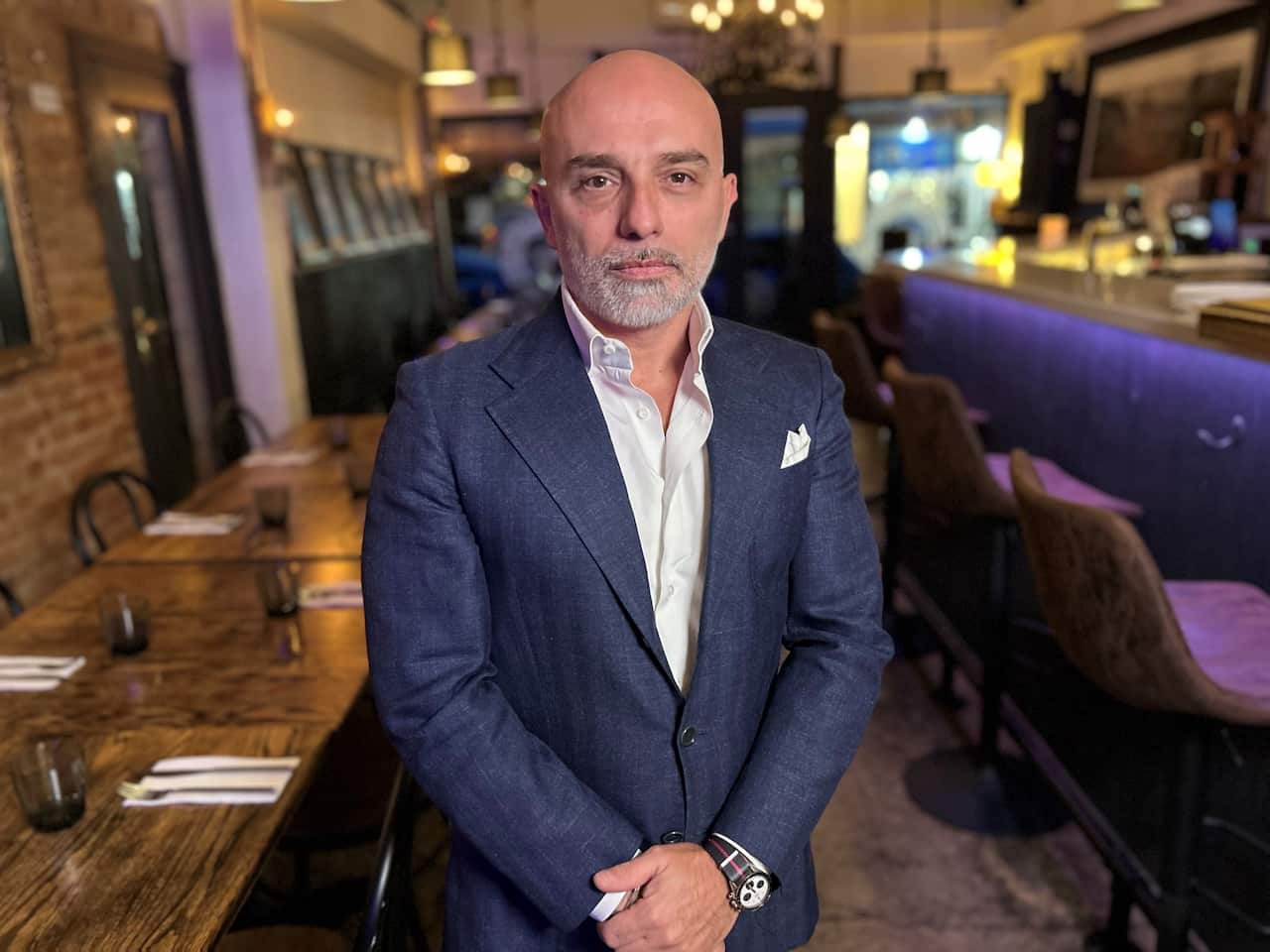 Stefano Maffei standing in the dining room of his Italian restaurant.