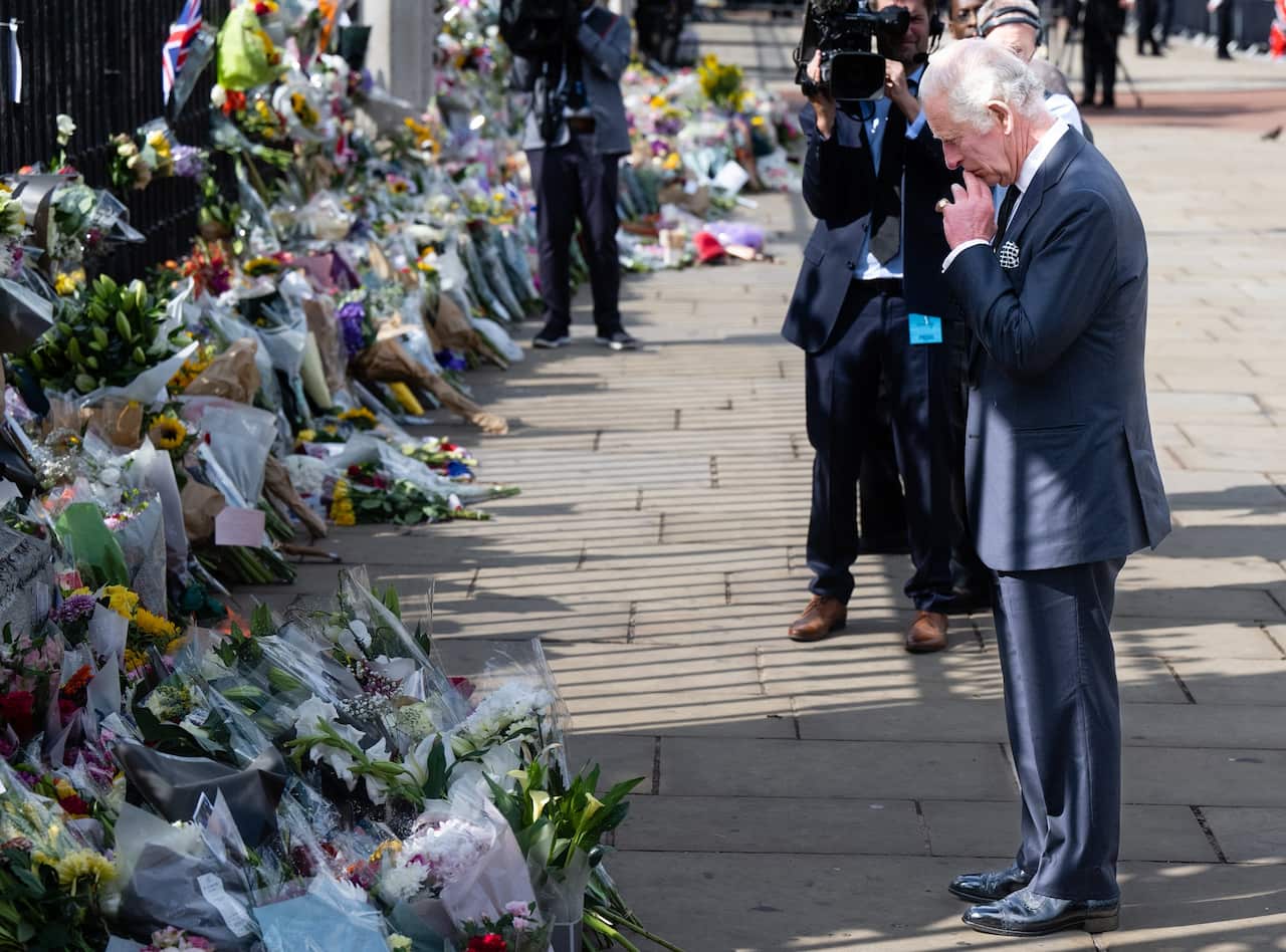 King Charles III views floral tributes to the late Queen Elizabeth II outside Buckingham Palace on 9 September 2022 in London, United Kingdom. 