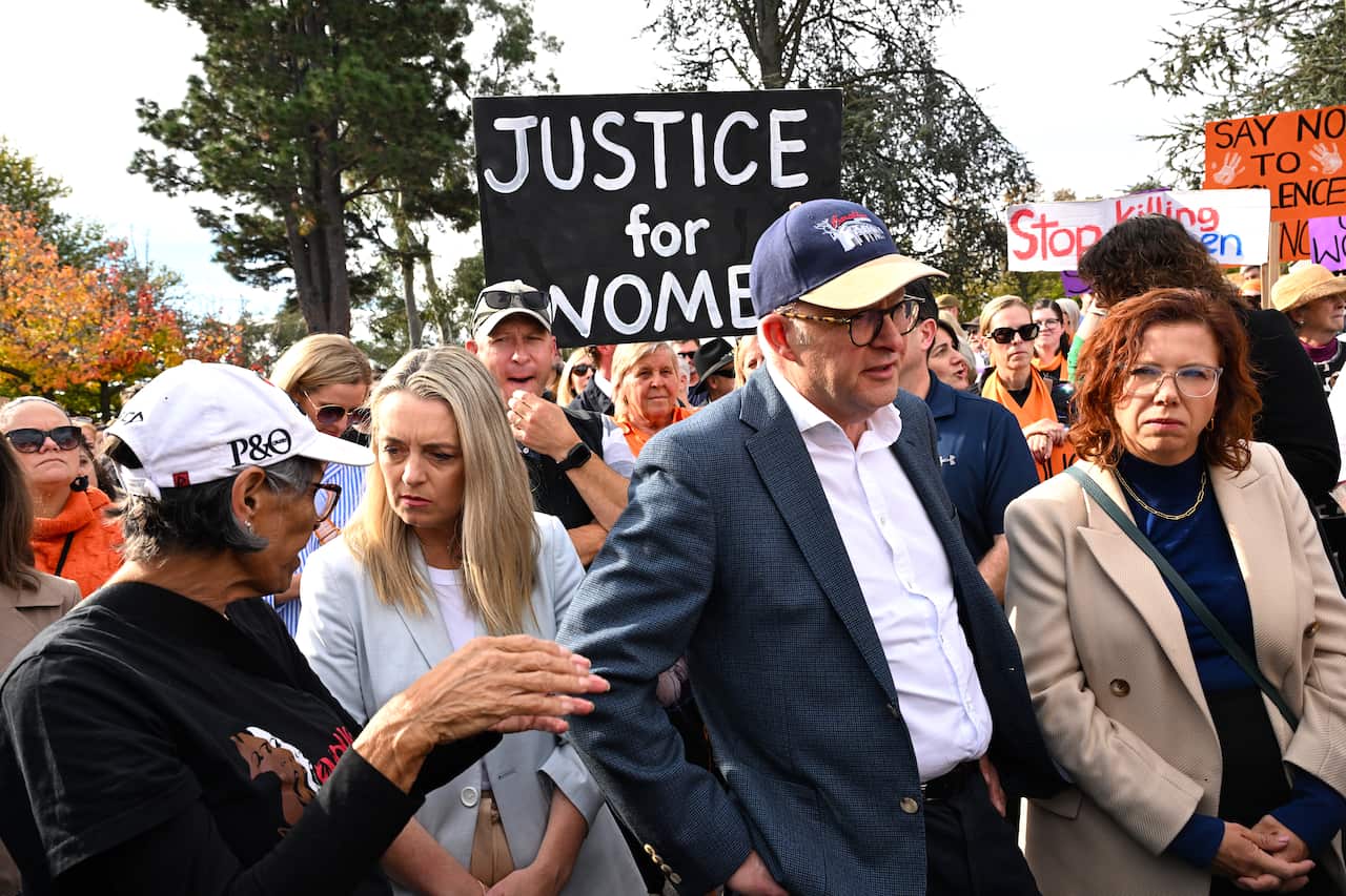 Prime Minister Anthony Albanese and Social Services Minister Annika Wells march at a rally