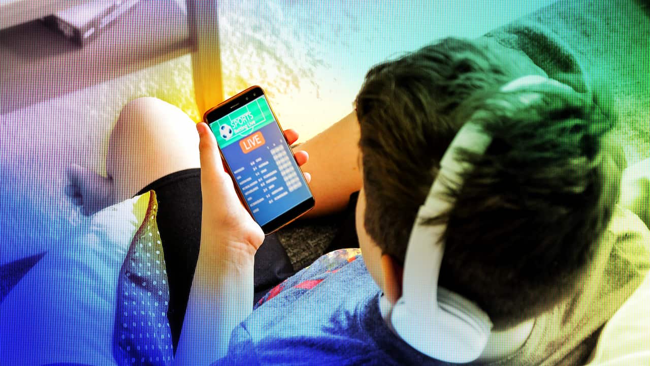 a boy wearing headphones on a mobile phone and looking at a sports betting site