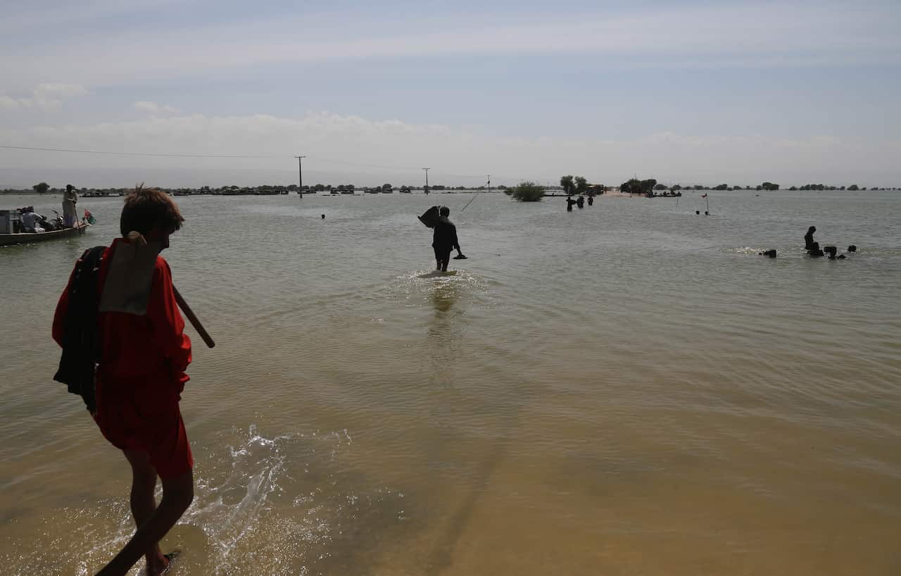 People affected by floods move to higher grounds in Sehwan, Sindh province, Pakistan, 01 September 2022. 