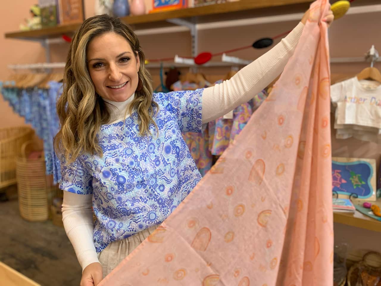 Corina Muir holds up a muslin wrap 