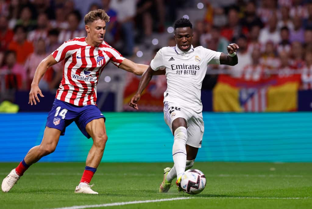 Vinicius Jr (right) playing football for Real Madrid