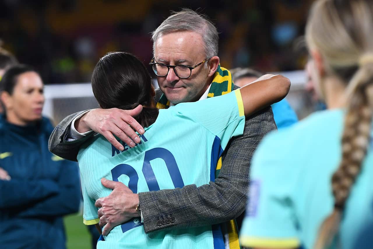 A man consoles a woman.