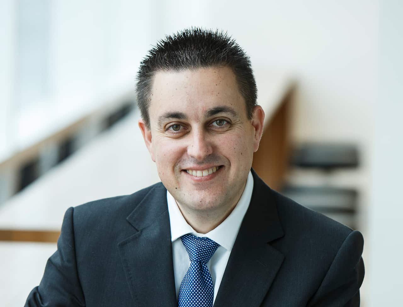 A man in a suit and tie looking at camera