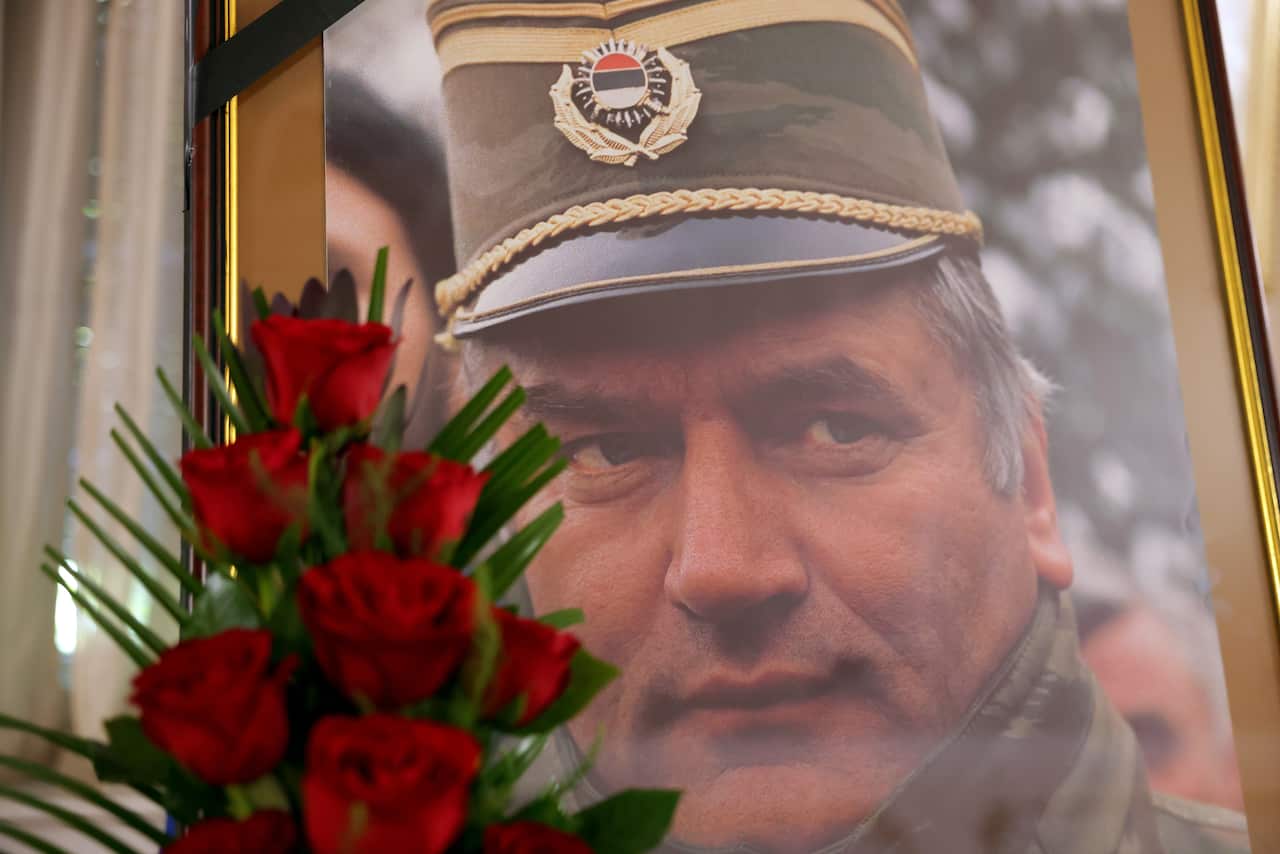 Ratko Mladic's portrait behind a bouquet of roses.
