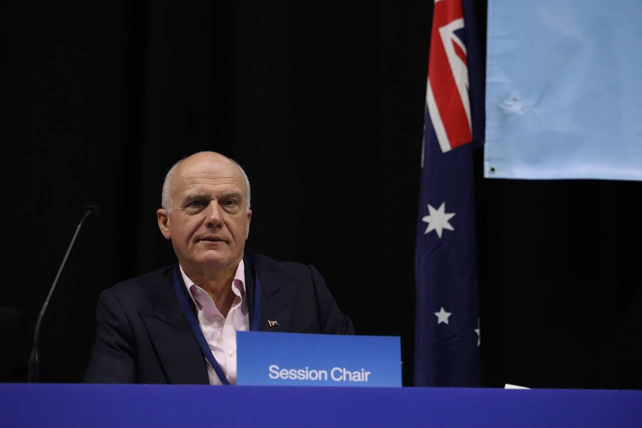 Eriz Abetz sits behind sign that says 'session chair'.