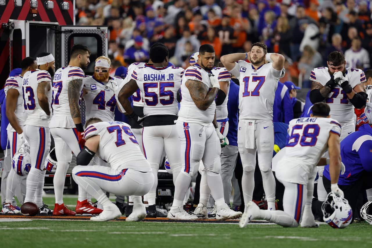 Buffalo Bills players react after teammate Damar Hamlin #3 was injured during the first quarter of the game at Paycor Stadium in Cincinnati, Ohio. 