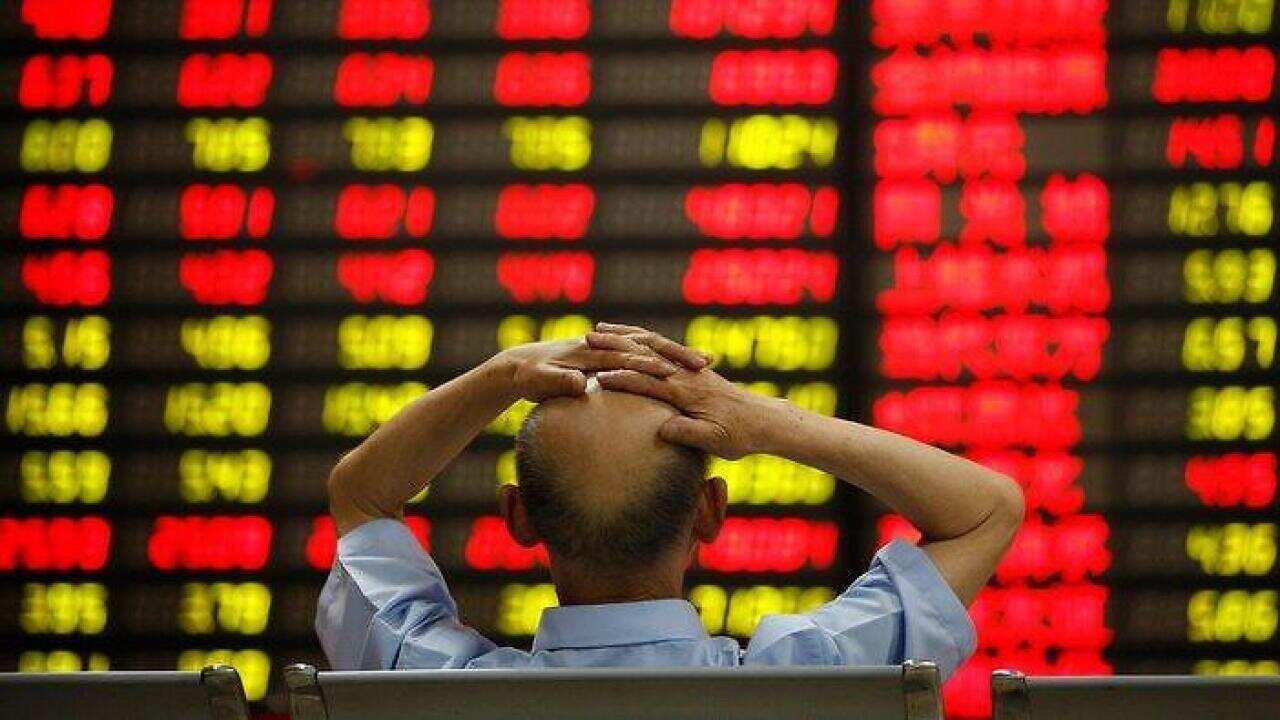 A man looking at the billboard of Shanghai Corporate Index