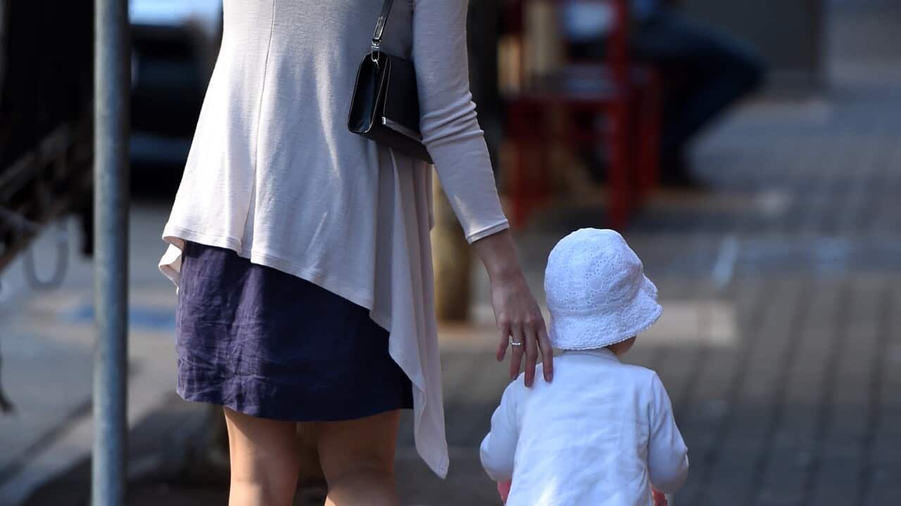 A stock image of a woman and a toddler pushing a toy stroller, walking in central Brisbane in Brisbane, Wednesday, April 29, 2015. (AAP Image/Dan Peled) NO ARCHIVING