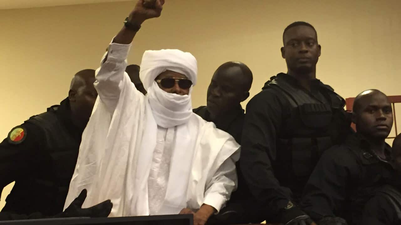 Chad's former dictator Hissene Habre razes his hand during court proceedings in Dakar, Senegal, Monday, May 30, 2016.