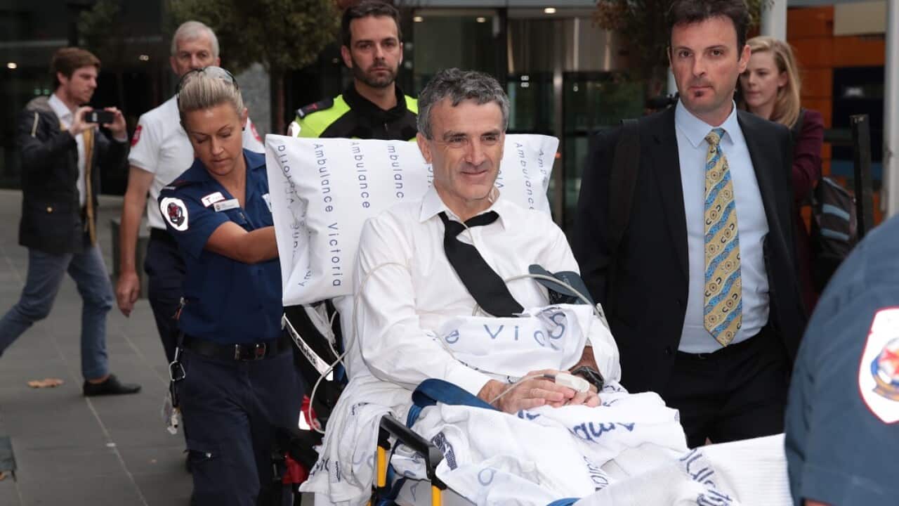 Terry McMaster leaves the Federal Court with the aid of paramedics