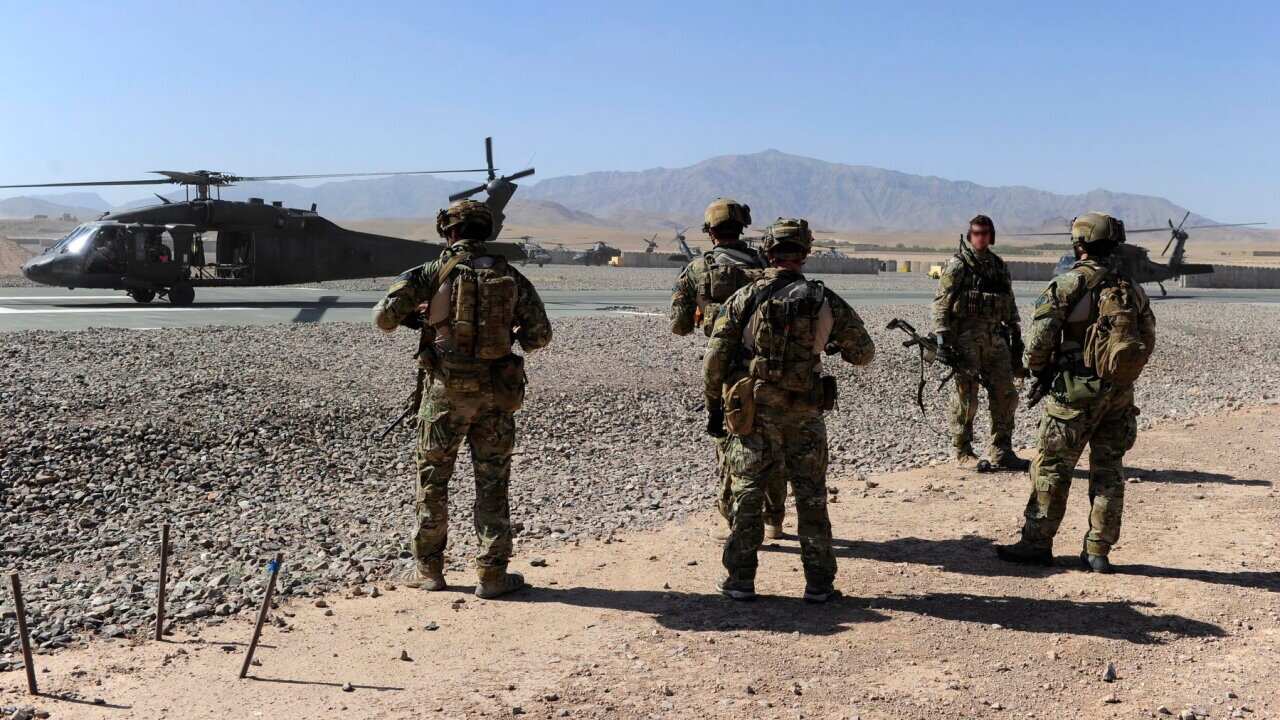 Australian Special Operations Task Group Soldiers move towards waiting UH-60 Blackhawk helicopters as part of the Shah Wali Kot