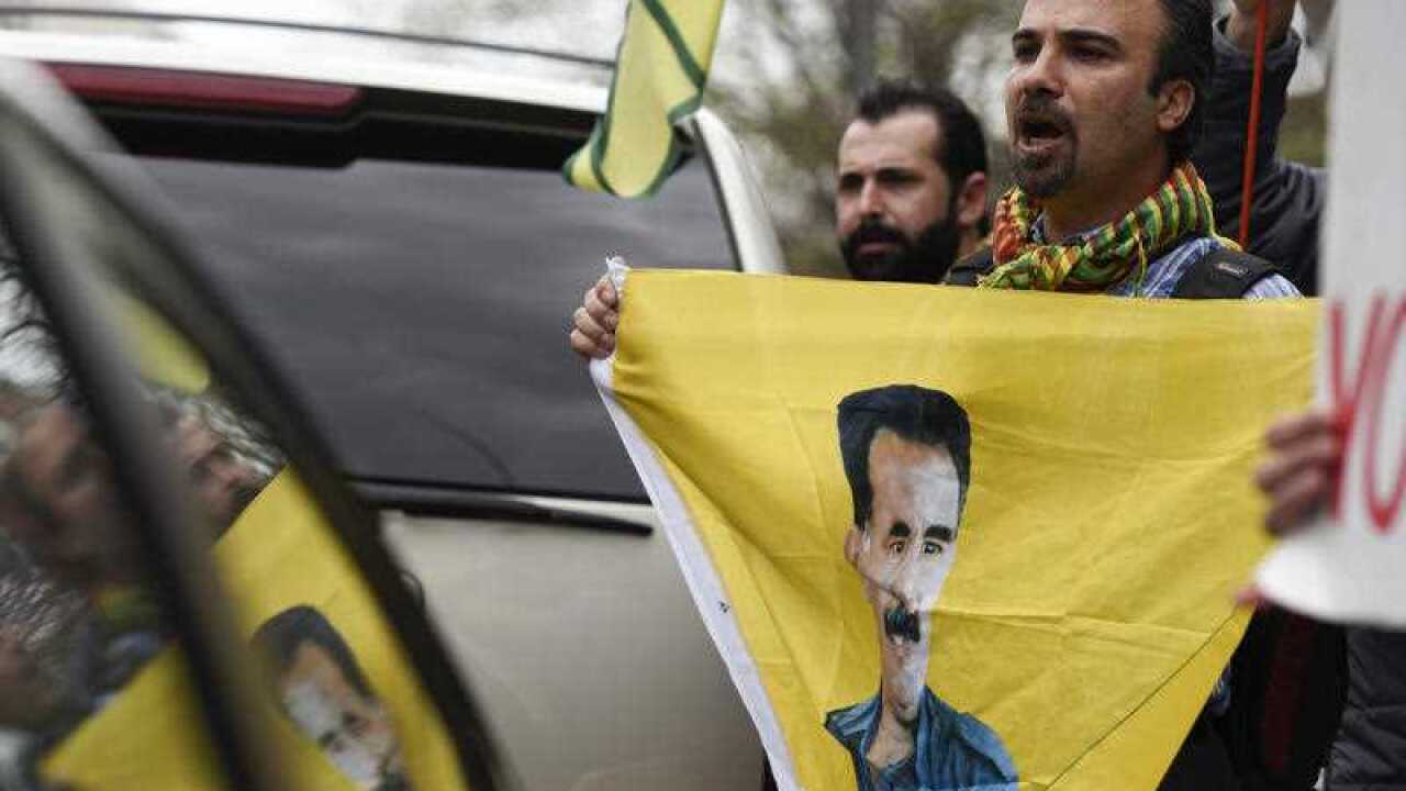 A protester holds a banner with a portrait of Abdullah Ocalan, the imprisoned leader of PKK, the militant Kurdish Workers Party, in Washington.